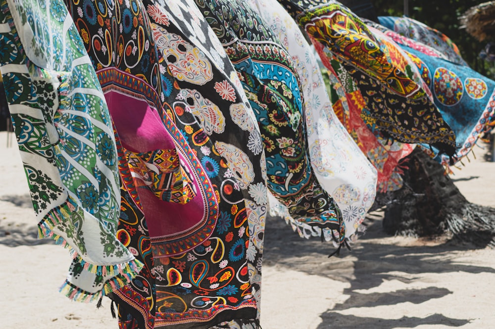 a row of colorful scarves hanging from a line