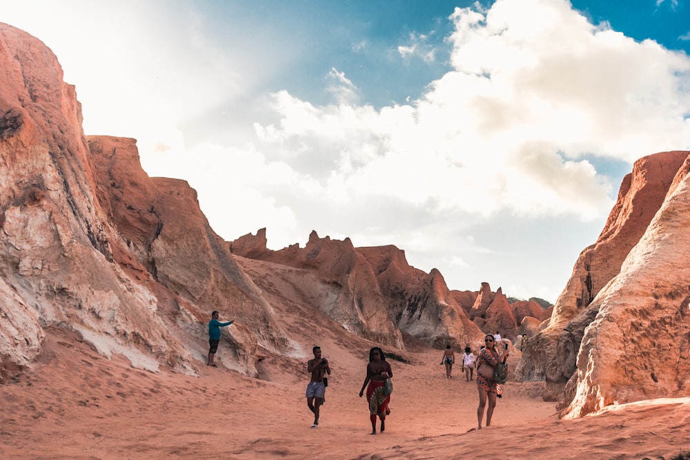 a group of people walking through a desert