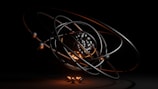A dark, abstract, and futuristic representation of an atom, featuring a cluster of metallic spheres at the center surrounded by orbiting rings. The orange and black lighting adds a dramatic effect, emphasizing the spherical forms and giving a sense of depth.
