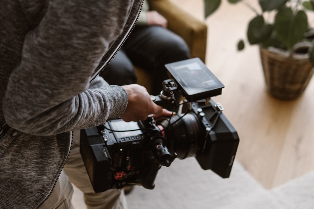 a person holding a camera in their hand