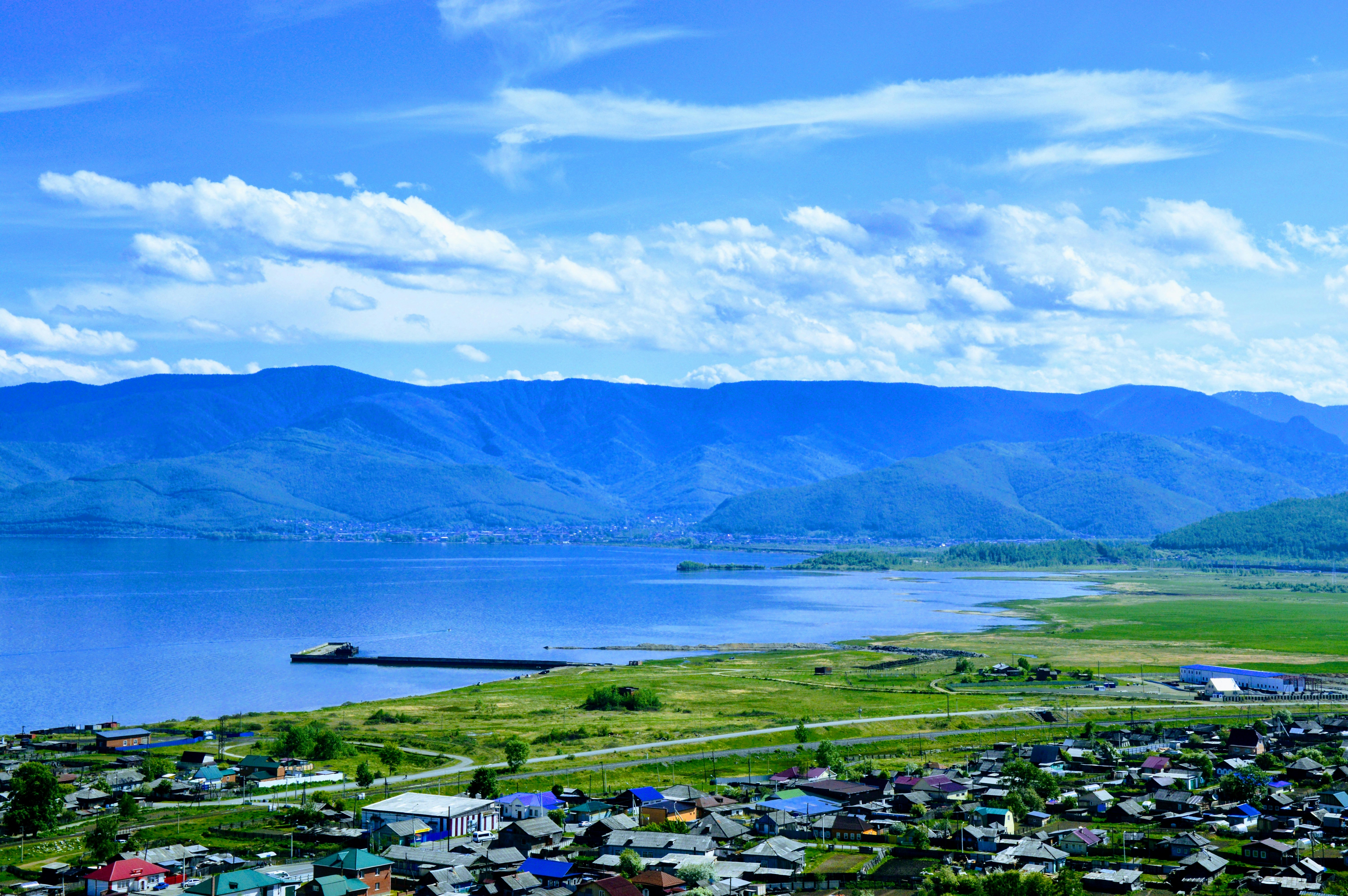 a scenic view of a town and a body of water