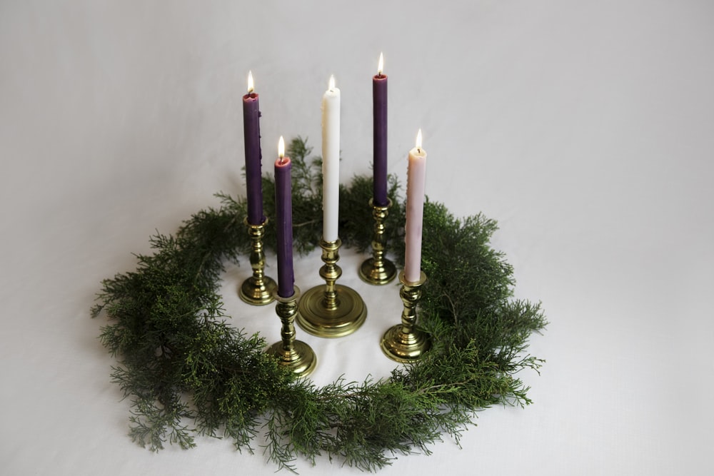 a group of candles sitting on top of a wreath