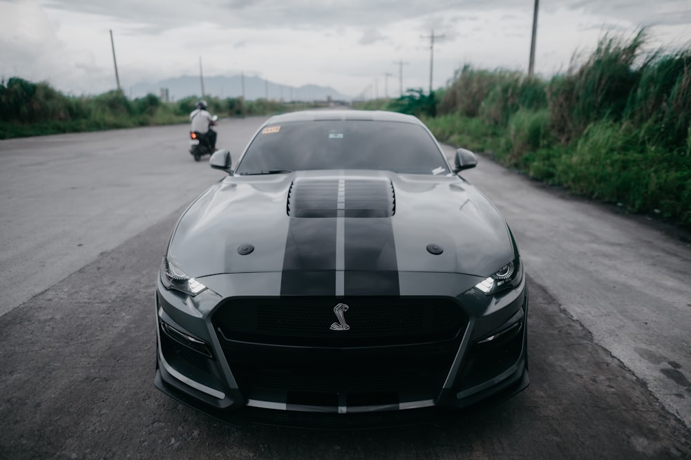 a black sports car parked on the side of the road