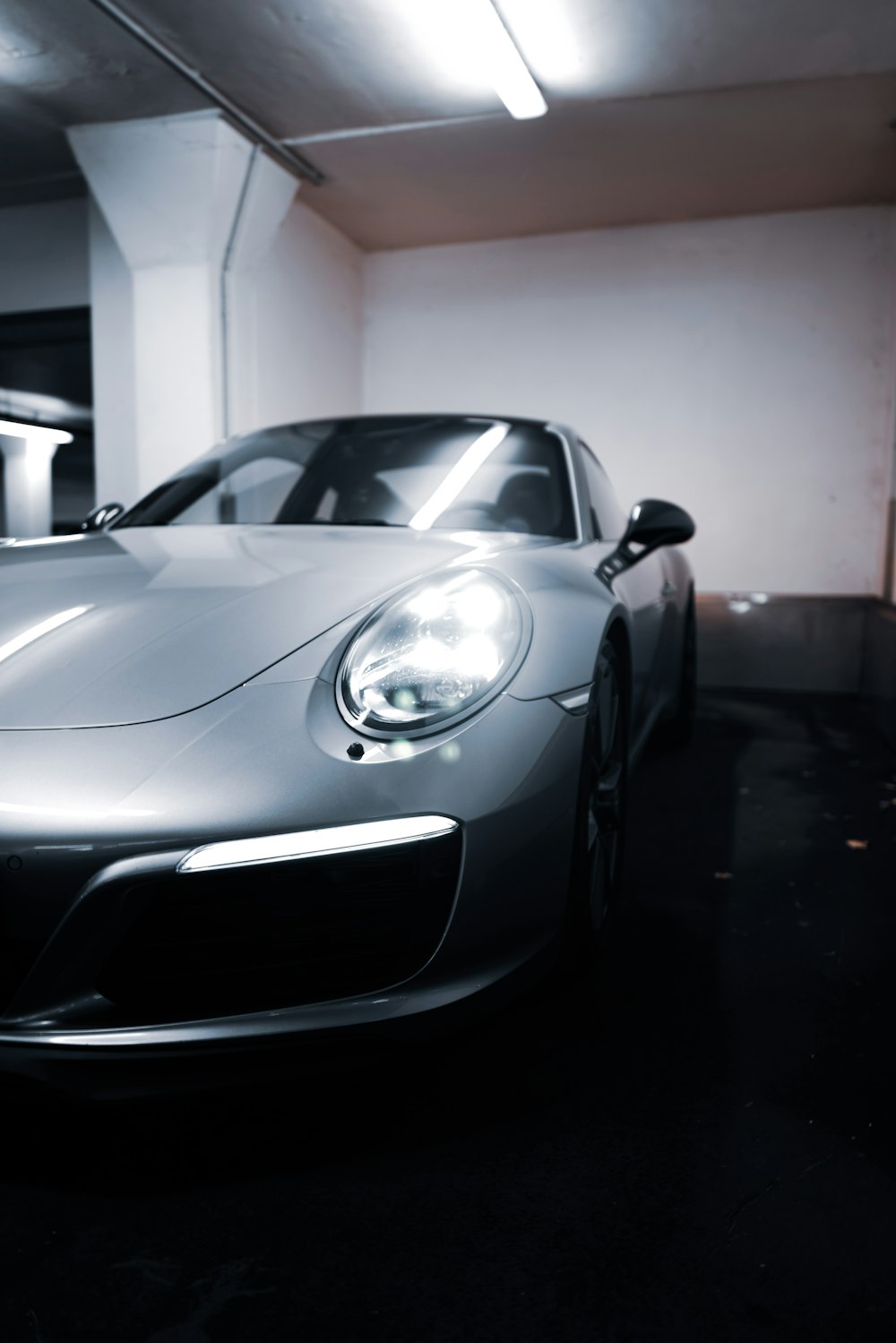 a silver sports car parked in a garage