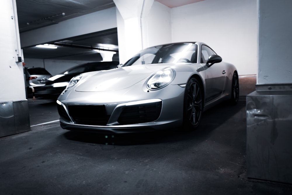 a silver sports car parked in a parking garage