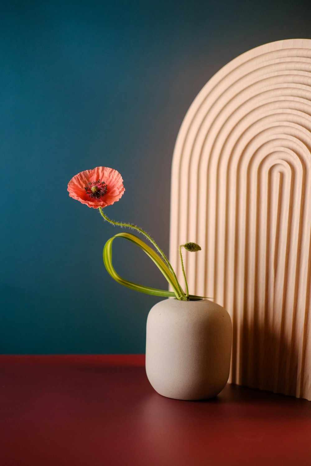 a small vase with a single flower in it