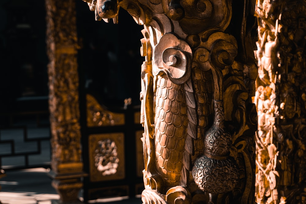 a close up of a wooden carving on a wall