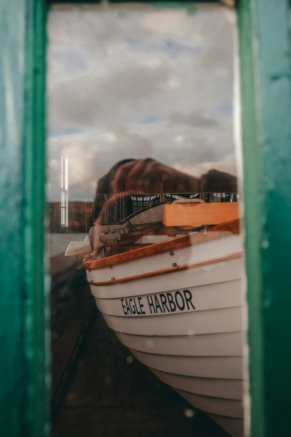 a reflection of a boat in a window