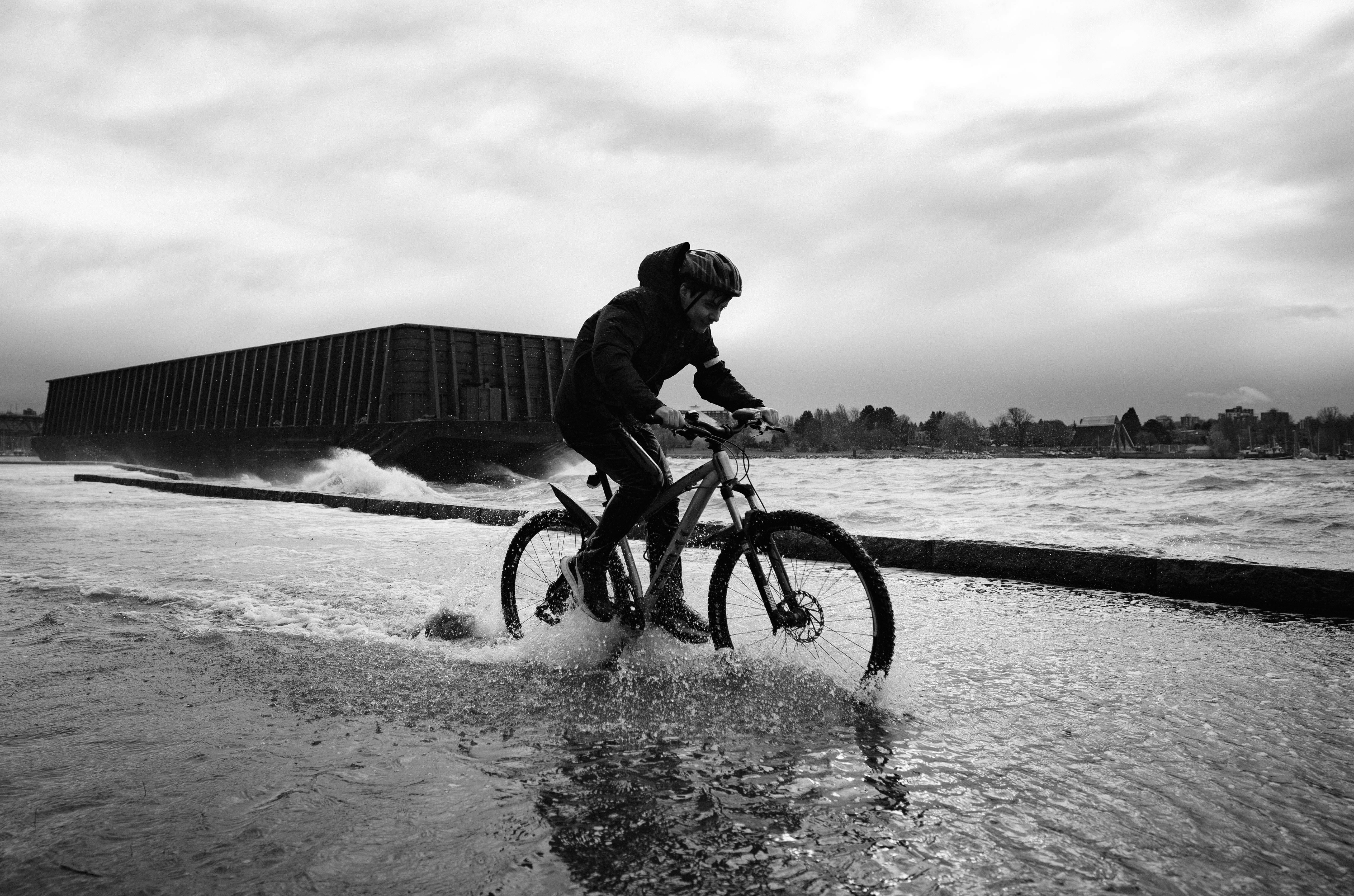 a person riding a bike through a body of water