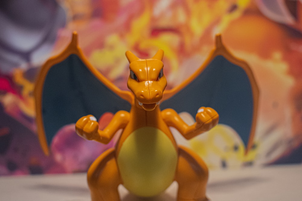 a toy figure of a yellow pokemon sitting on top of a table