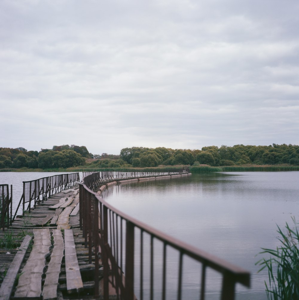 a long wooden dock sitting next to a large body of water