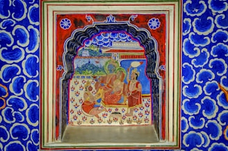 a blue and red wall with a painting on it