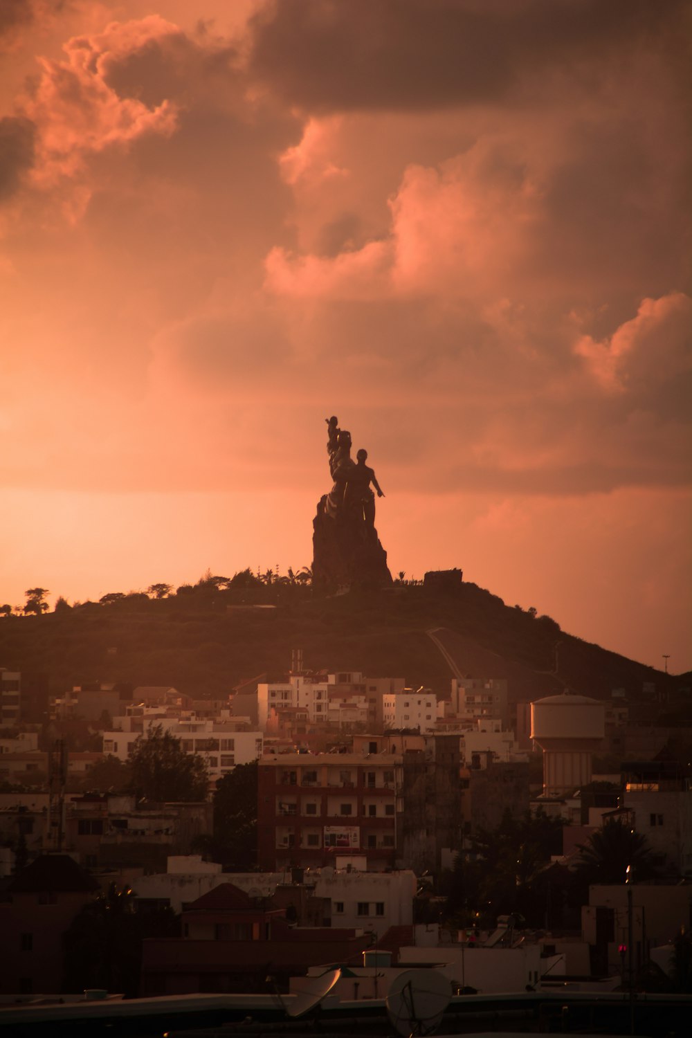 una vista de una colina con una estatua en la cima