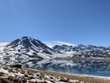 a mountain range with a lake in the foreground