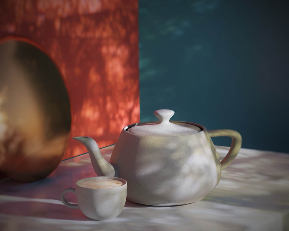 a tea pot and a cup on a table