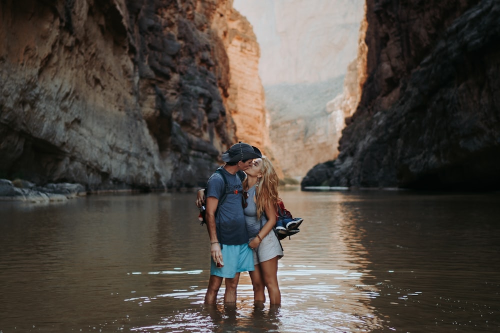 a man and a woman are standing in the water