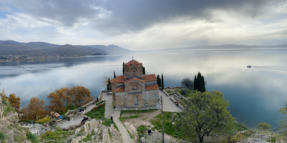 a church on a cliff overlooking a body of water