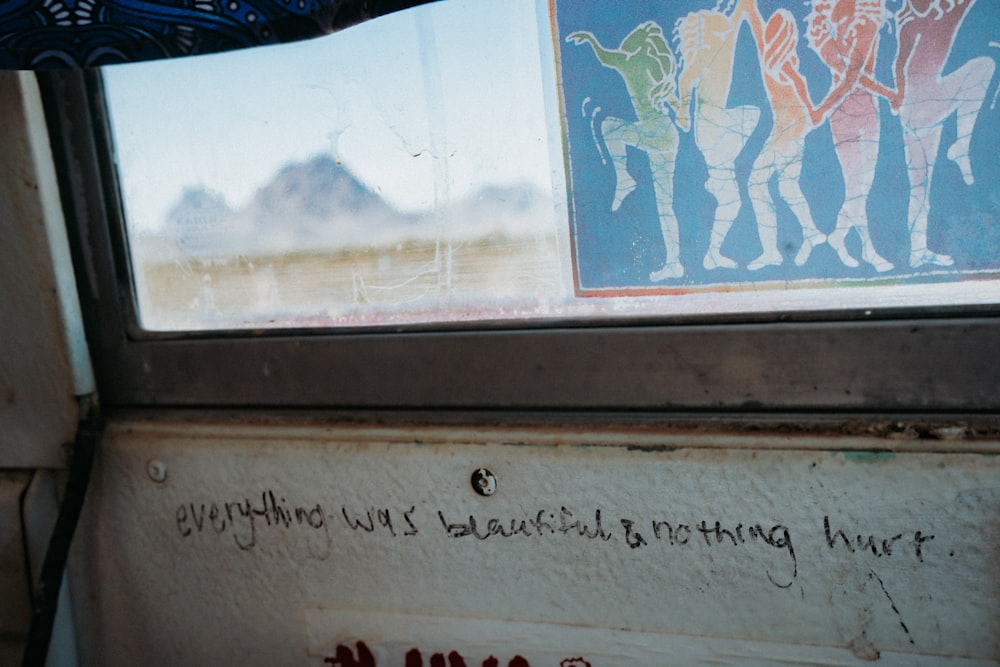 graffiti on the side of a bus window