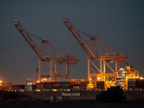 a couple of cranes that are sitting in the sky