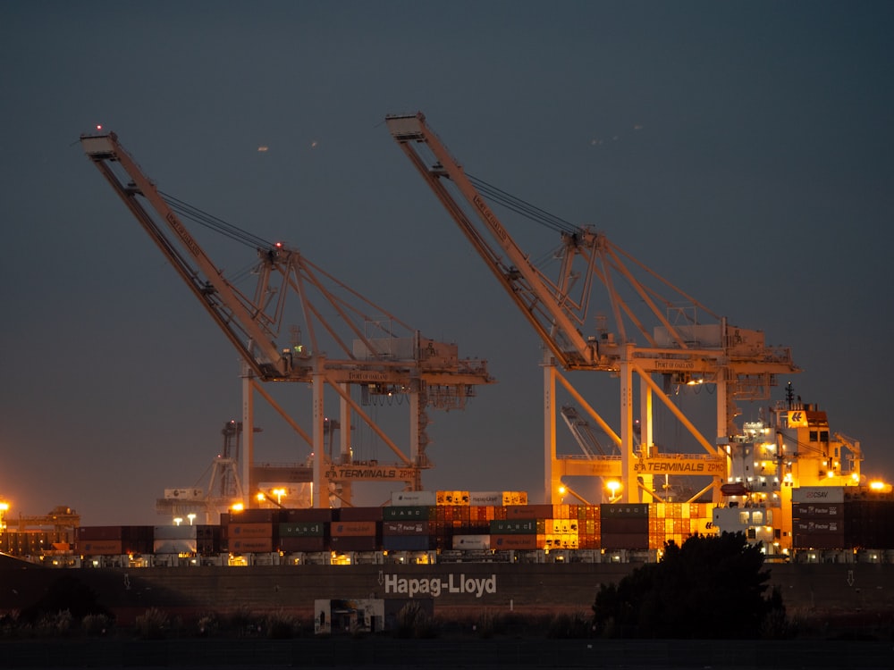 a couple of cranes that are sitting in the sky