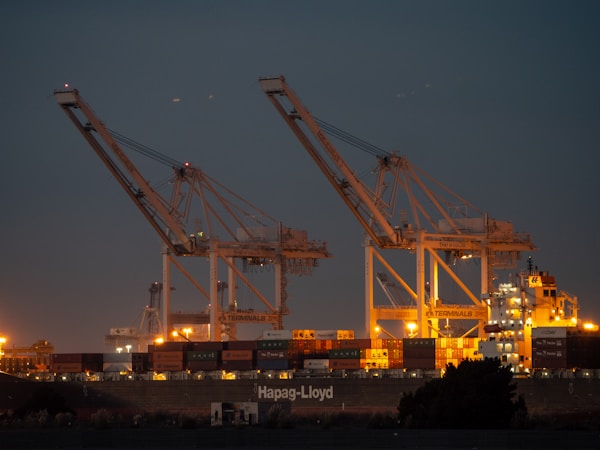 a couple of cranes that are sitting in the skyby Ronan Furuta