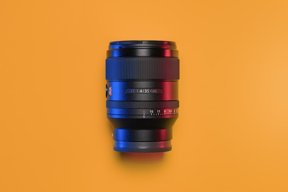 a camera lens sitting on top of a yellow surface