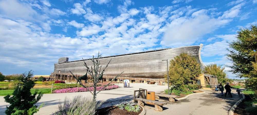 a large wooden structure sitting on top of a lush green field