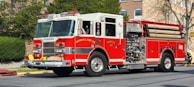 a red fire truck driving down a street