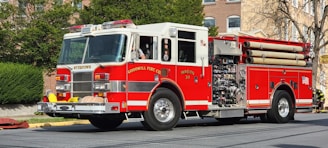 a red fire truck driving down a street
