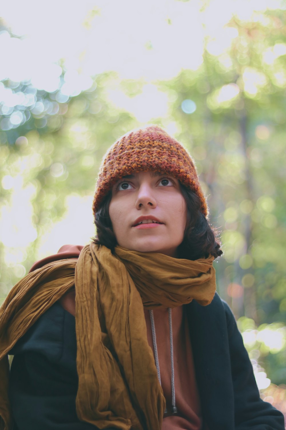 a woman wearing a brown hat and scarf