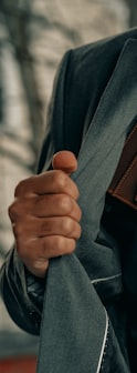 a man holding a wallet and a watch