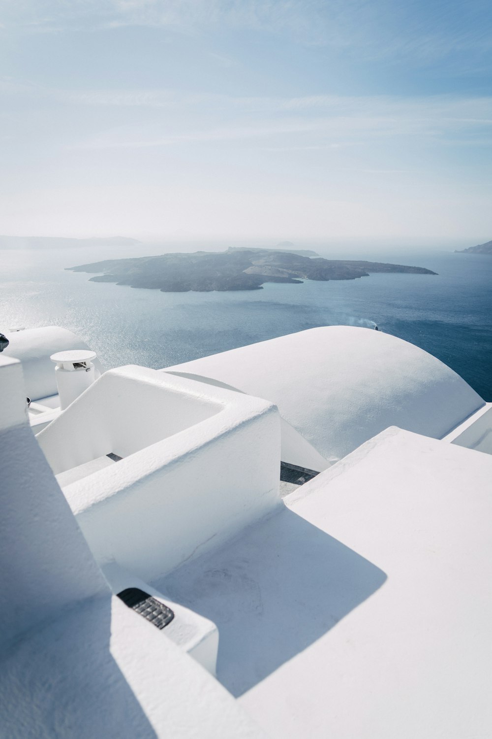 a white building with a view of a body of water