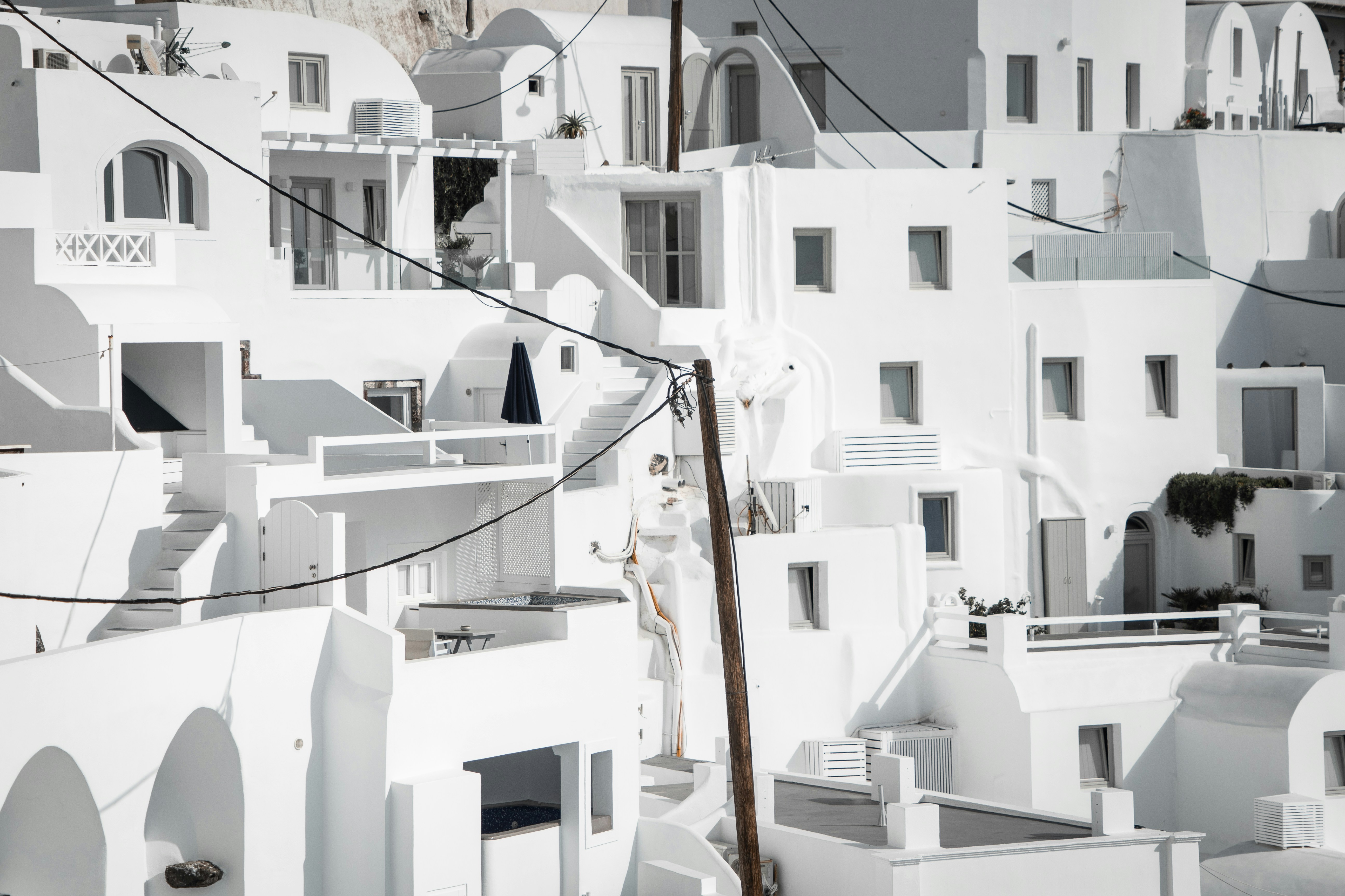 a black and white photo of buildings and a telephone pole