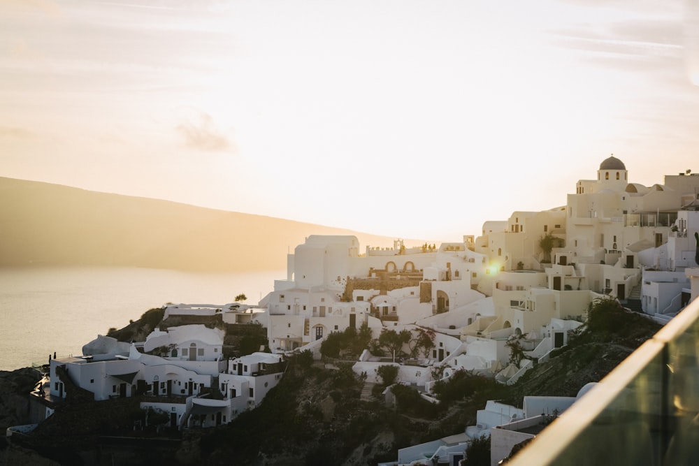 the sun is setting over a white village