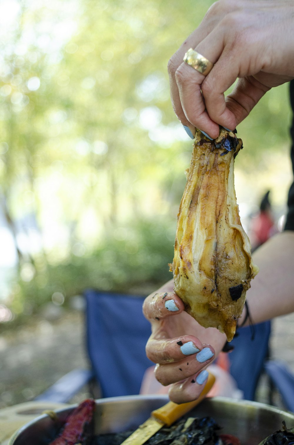 a person holding a piece of meat in their hand