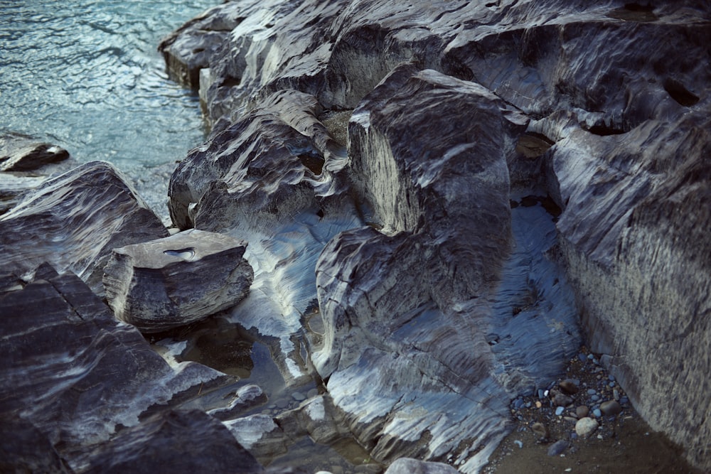 some rocks and water on a rocky shore