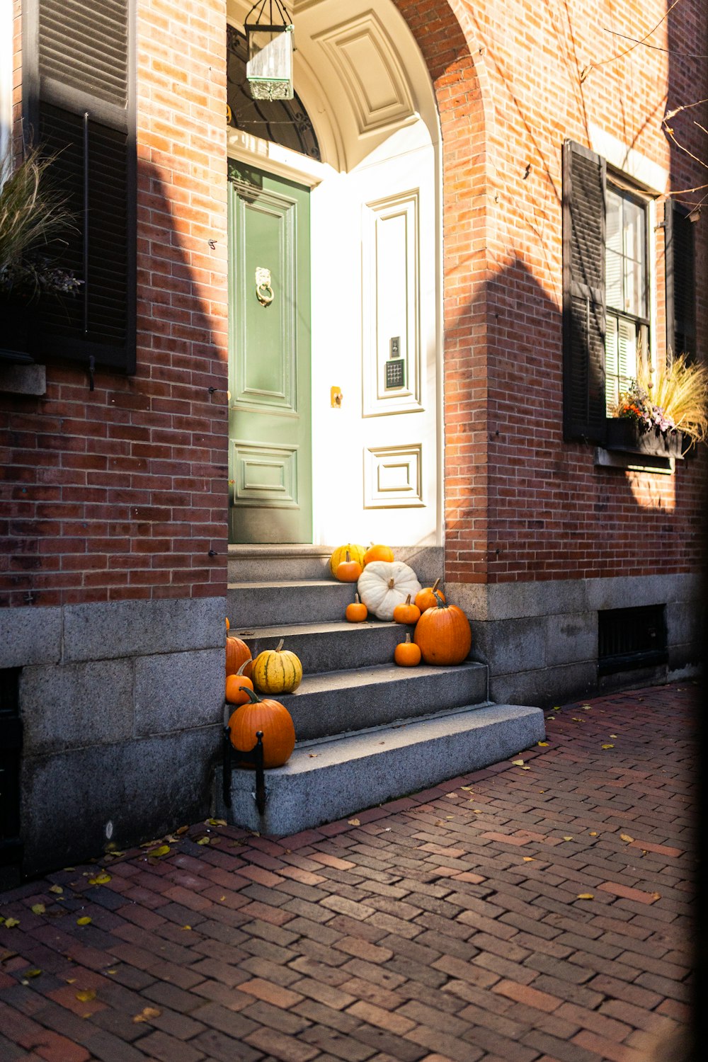 a bunch of pumpkins sitting on the steps of a house
