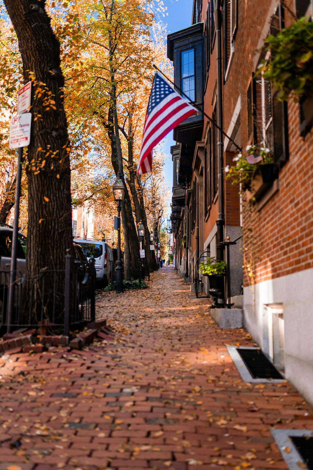 a brick sidewalk with a flag on it