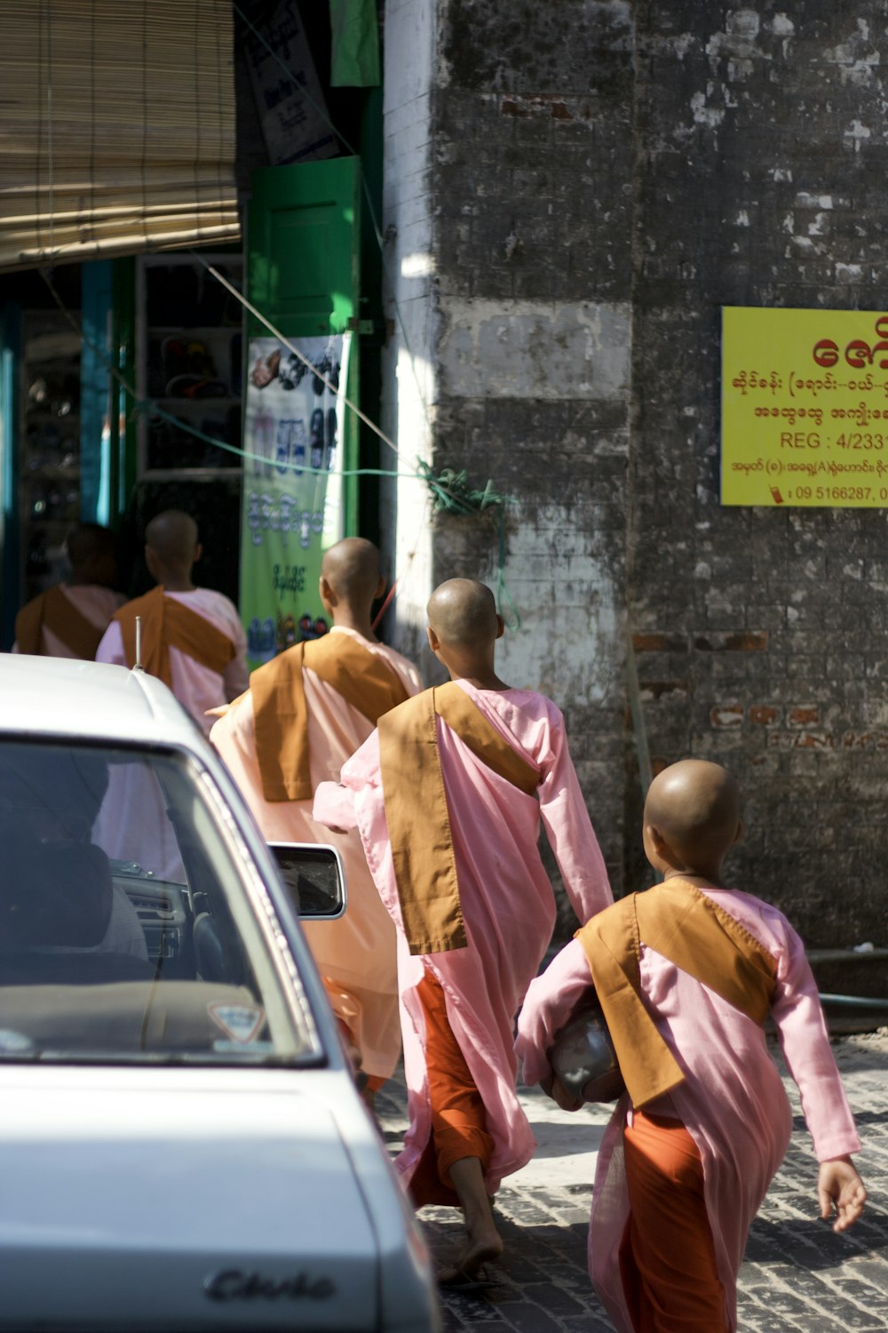 a group of monks walking down a street