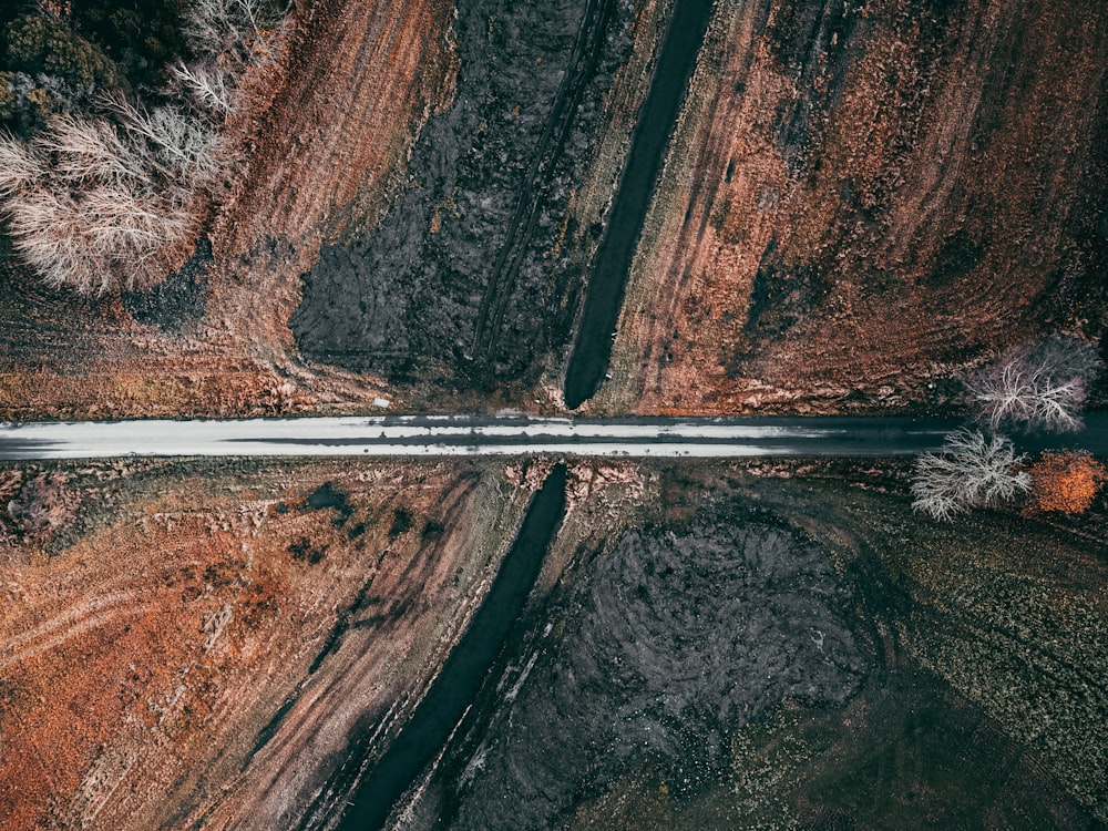 an aerial view of a road surrounded by trees