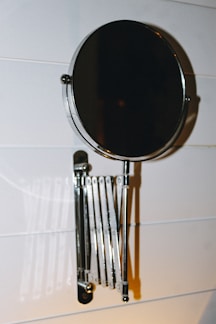 A stylish wall mirror with a modern stand.