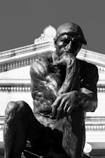 a black and white photo of a statue of a man