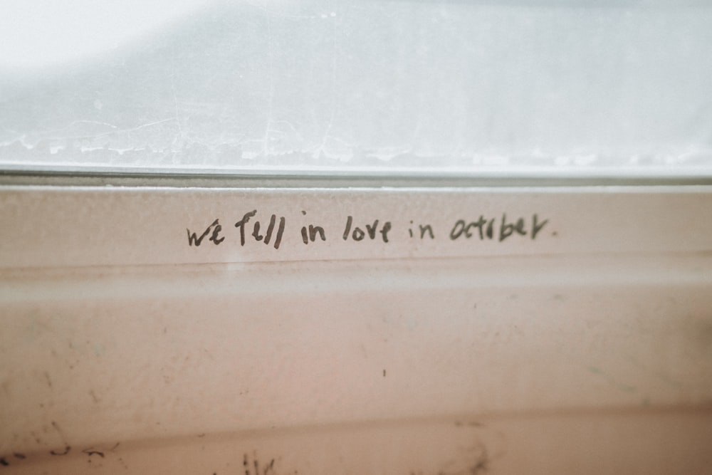 a close up of writing on a window sill