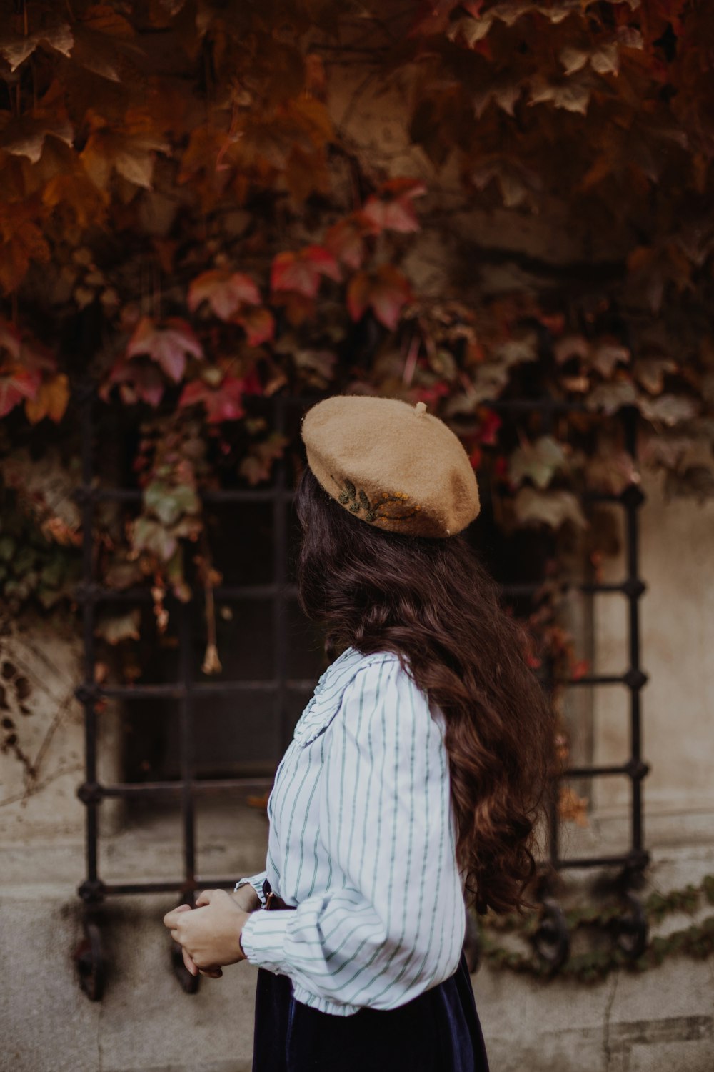 a woman with long hair wearing a hat