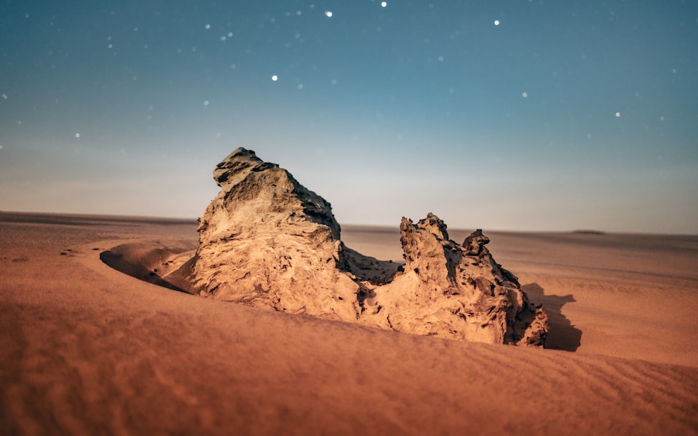 a rock formation in the middle of a desert