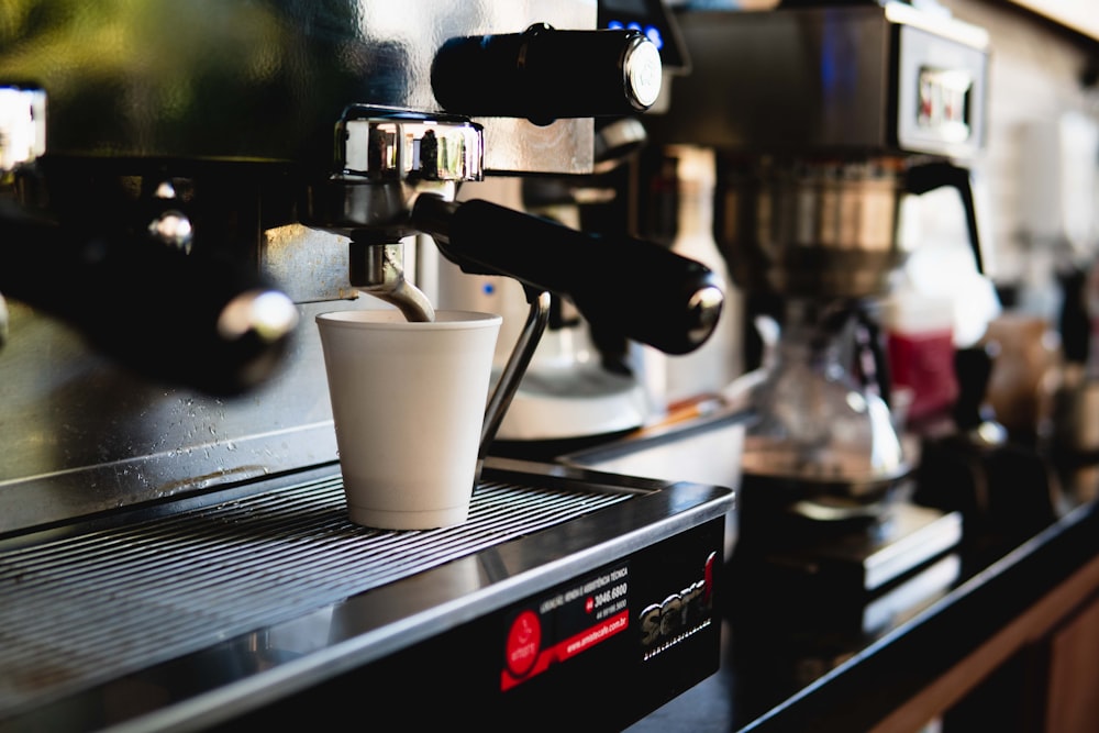 a coffee machine with a cup of coffee on top of it