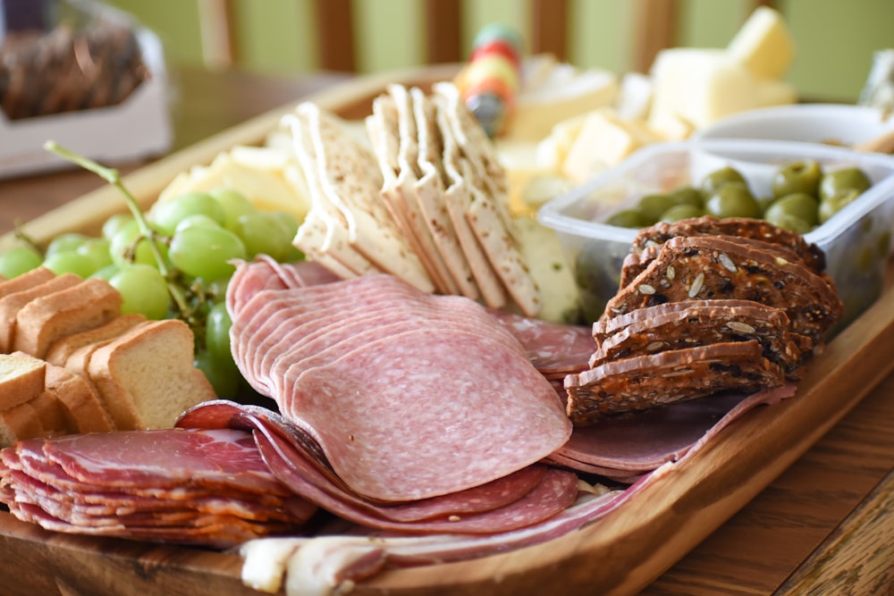 a platter of meats, cheeses, and crackers