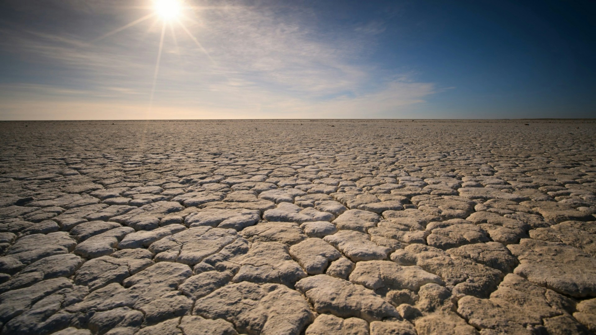 the sun is shining over a vast expanse of land