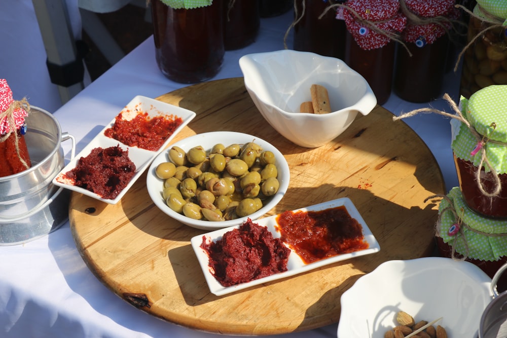 a wooden tray topped with bowls of food