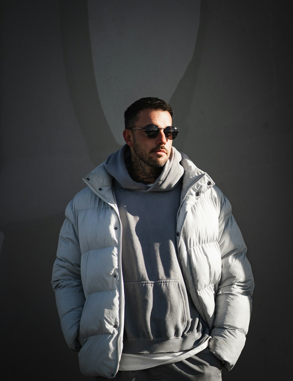 a man with a beard wearing a jacket and sunglasses